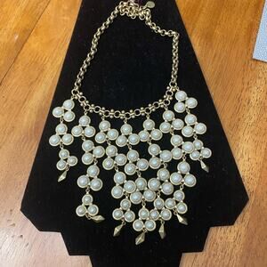 This beautiful Pearl and brass colored necklace